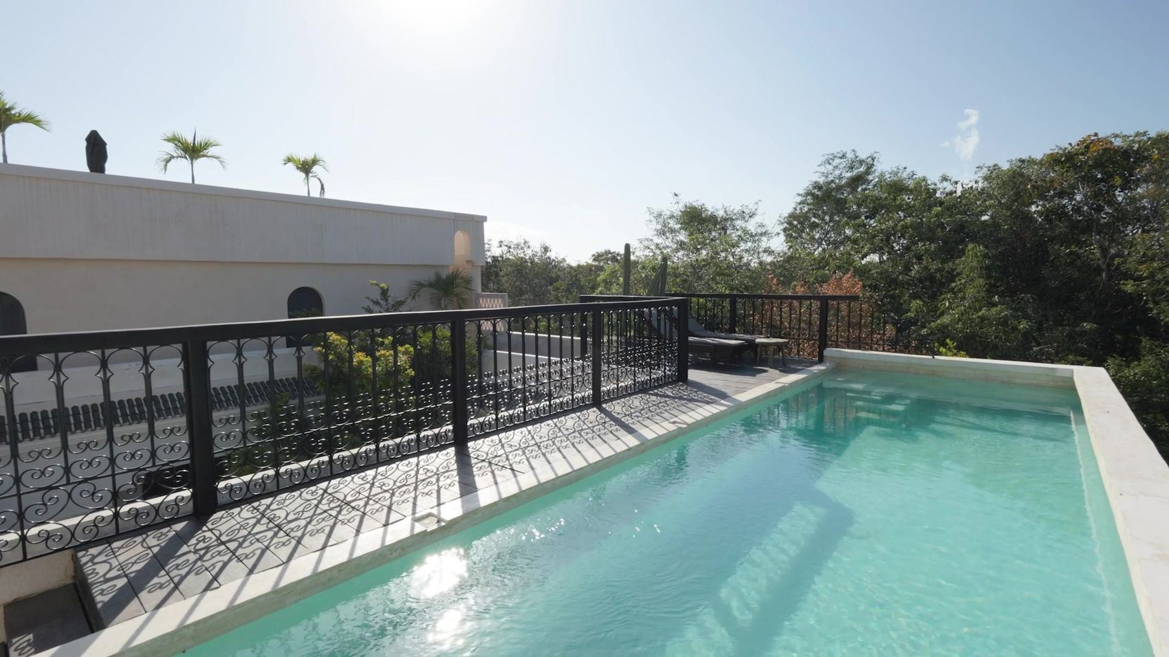 Rooftop with infinity pool above the jungle