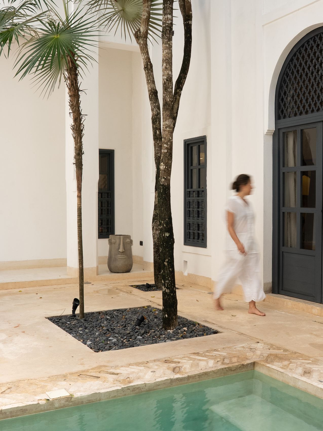 A guest walking through the villa courtyard
